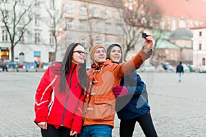 Friends tacking selfies with wearable camera in a touristic city photo