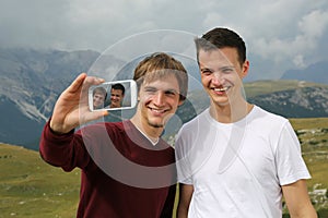 Friends taking pictures with a smartphone on holiday