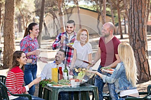 Friends taking pictures together at barbecue