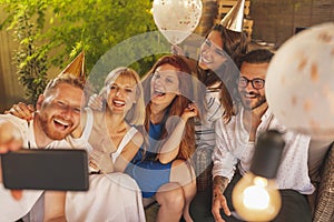 Friends taking a selfie at birthday party