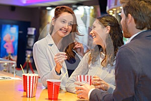 friends talking in cinema lobby