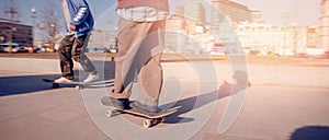 Friends team rides on skateboards, photography in motion. Concept active sport banner sunlight