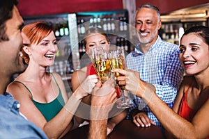 Friends toasting champagne glass in nightclub