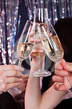 Friends toasting champagne at nightclub