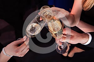 Friends toasting champagne at nightclub