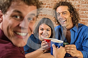 Friends Toasting with Coffee Mugs