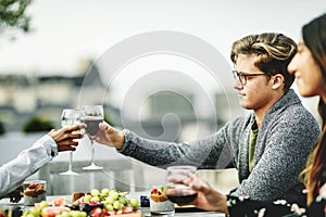 Friends toasting at a rooftop vegan dinner party