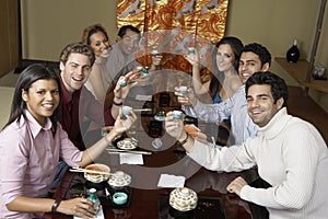 Friends Toasting Saki Cups