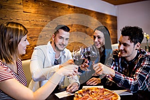 Friends toasting wine at table