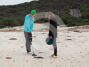 Friends on treasure hunt at Australian beach landscape