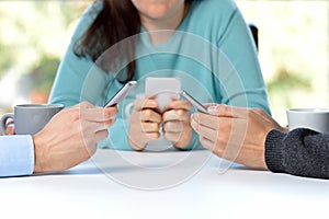 friends using their smartphones at the bar