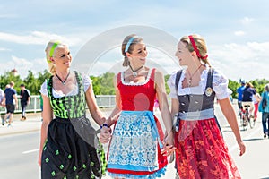 Friends visiting Bavarian fair having fun