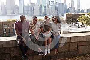 Friends Visiting New York With Manhattan Skyline In Background