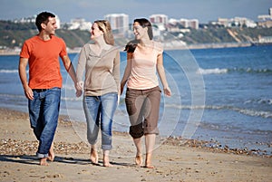 Friends walking along beach