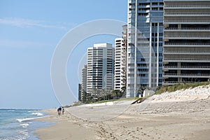 Friends walking along Singer Island beach front condos