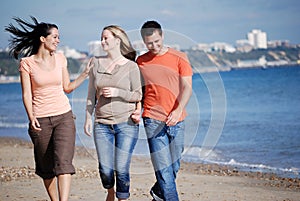 Friends walking together at the beach