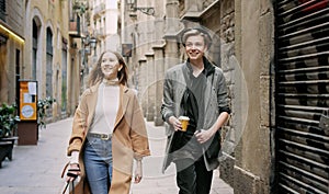 Friends walking together through tight street.