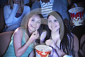 Friends Watching Film In Movie Theater