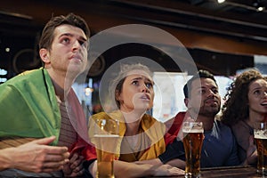 Friends watching match at the pub