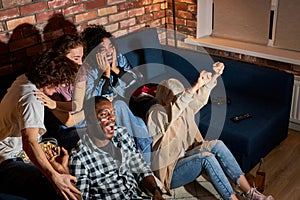 Friends Watching Sport Celebrating Goal, While Watching Competition On TV