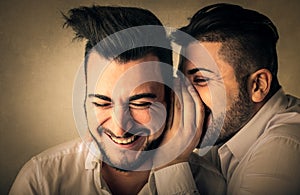 Friends whispering secrets