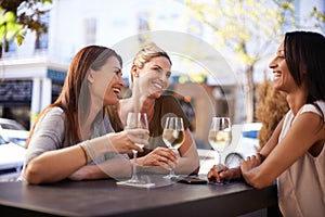 Friends, wine and women drinking at restaurant with laughing, bonding and relax outdoor in city for celebration. People