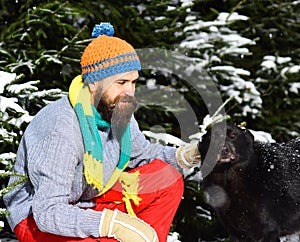 Friendship and allegiance concept. Man wears knitted hat, scarf, gloves photo