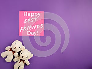 Friendship Celebration Concept - Happy best friend day text written on notepaper with teddies background. Stock photo