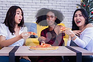 Friendship enjoy pizza on a table