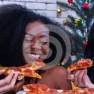 Friendship enjoy pizza on a table