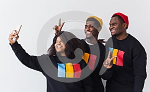 Friendship and fun concept - Group of friends afro american men and woman taking selfie in studio on white background.