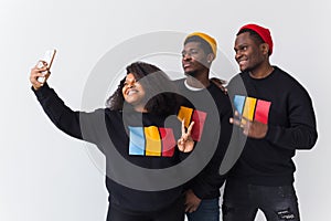 Friendship and fun concept - Group of friends afro american men and woman taking selfie in studio on white background.