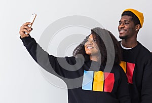 Friendship and fun concept - Group of friends afro american men and woman taking selfie in studio on white background.