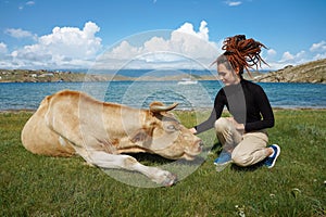 Friendship of human and animal. Girl and cow