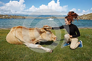 Friendship of human and animal. Girl and cow