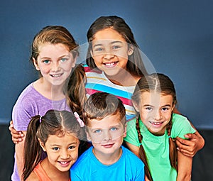 Friendship matters. Studio shot of a diverse group of kids posing together against a blue background.