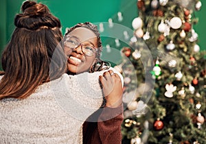 Friendship puts the merry in Merry Christmas. two happy young women hugging each other during Christmas at home.