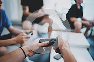 Friendship, technology, games and relaxing time at home concept - close up of male friends playing video games at living