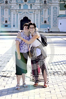 The friendship of two adult women lasts for a very long time Happy friends hug and hold each other, smile. Women travel