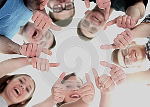 Friendship, youth and people concept - group of smiling teenagers with hands on top each other