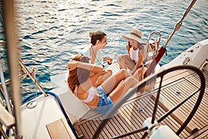 Friendâ€™s girl on the boat together enjoy at summer day