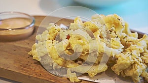 Fries calamari on wood platter appetiser