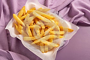 Fries portion on soft violet background