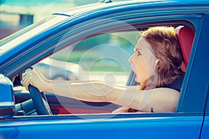 Fright face woman driving car wide open mouth eyes screaming photo