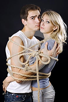 Frighten couple bound with ropes