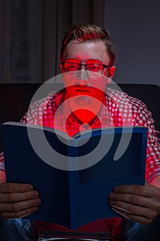 Frighten man reading horror