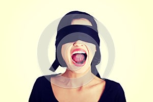 Frighten young blindfold woman screaming