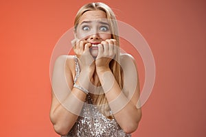 Frightened afraid panicking young cute blond woman biting nails pop eyes scared camera look terrified stunned speechless