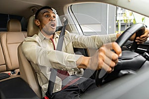 frightened african american man driving car at high speed crash survivor Oops, shock reaction.