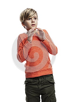 Frightened boy in an orange sweater. Fear, depression, stress.  on white background. Vertical